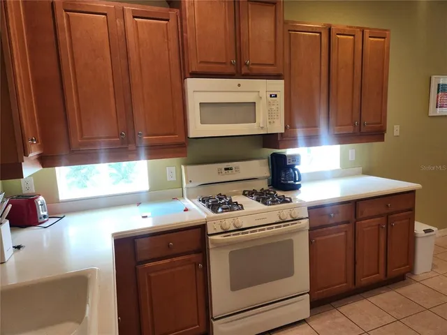 a kitchen with a stove microwave and sink