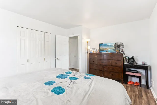 a bedroom with a bed and a dresser