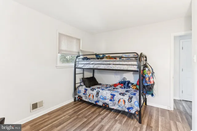 a bed sitting in a bedroom next to a window