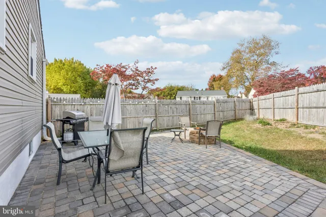 a view of a backyard with furniture and a garden