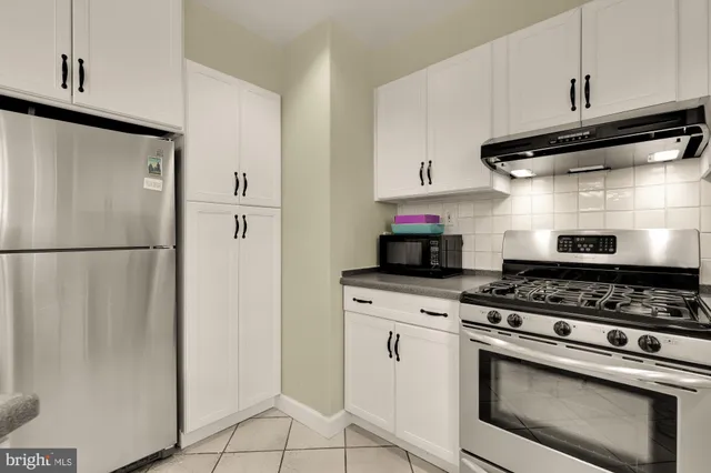 a kitchen with stainless steel appliances granite countertop a stove a refrigerator and a refrigerator