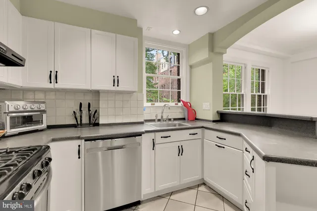 a kitchen that has a sink and a stove