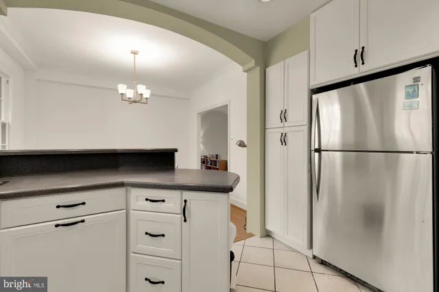 a kitchen with a refrigerator and cabinets
