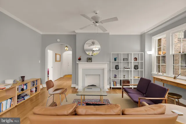 a living room with furniture a fireplace and a large window
