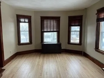 a living room with furniture window and wooden floor