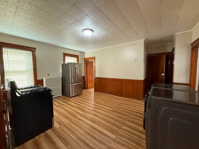 a bed room with a bed furniture and a flat tv screen
