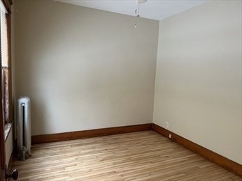 3 View Street, Unit 1 Worcester, MA 01610 - Photo 8 of 12 a view of an empty room with wooden floor and a window