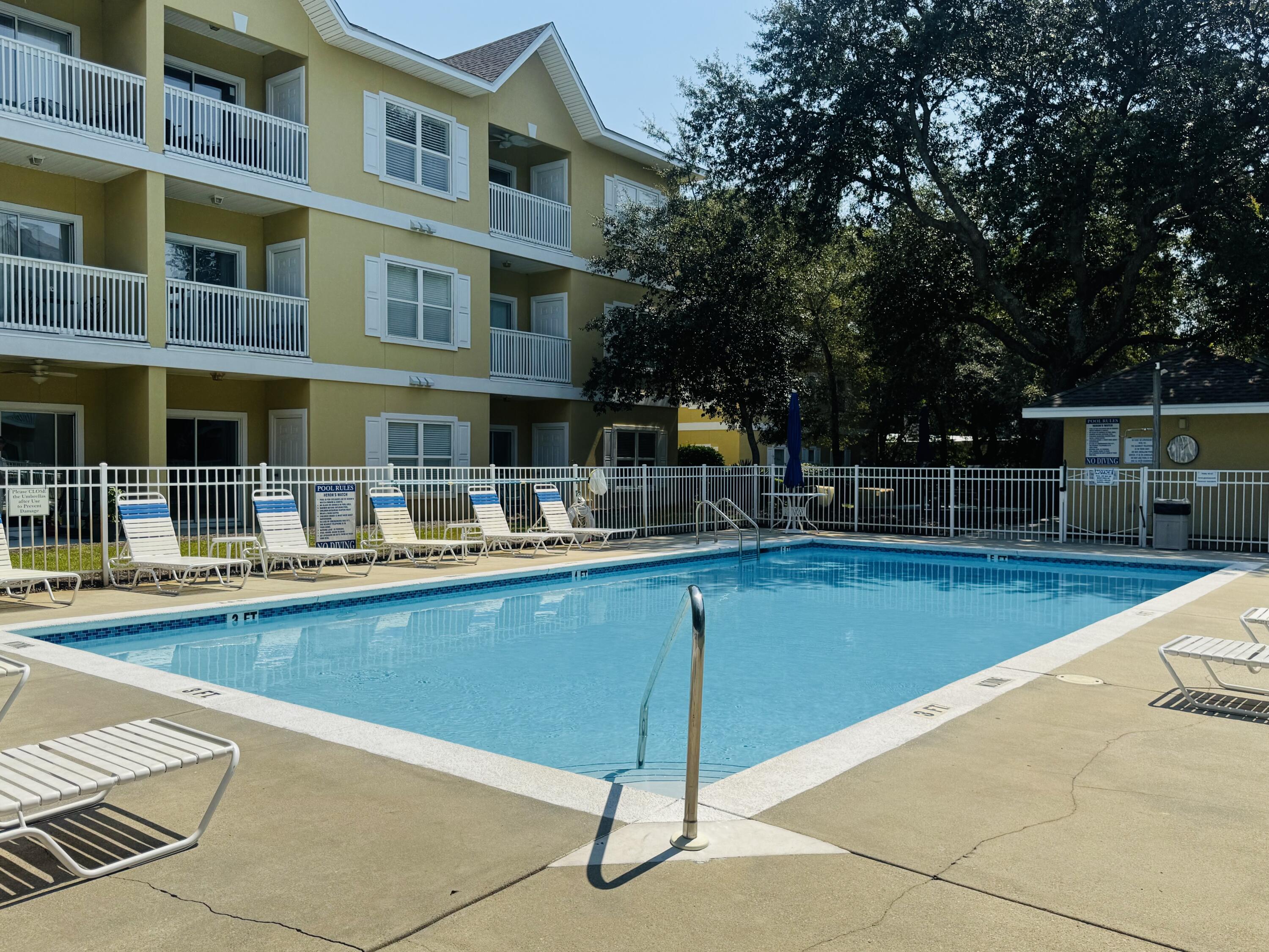 34 Heron's Watch Way, Unit 3202 Santa Rosa Beach, FL 32459 - Photo 13 of 15 a view of a swimming pool with a lounge chairs