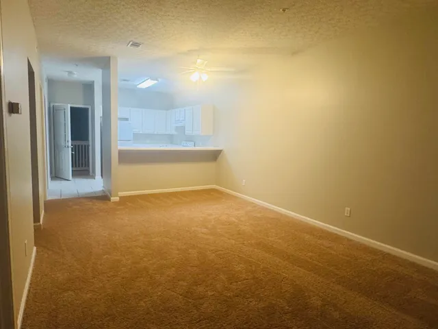 a kitchen with a sink a refrigerator and white cabinets