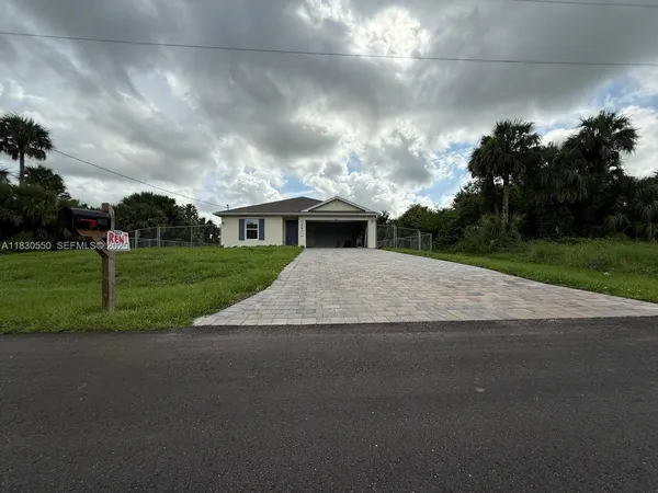 a aerial view of a house next to a yard