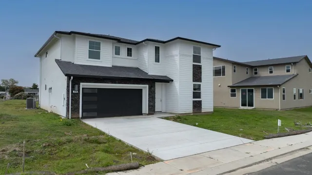 a front view of a house with a garden and yard