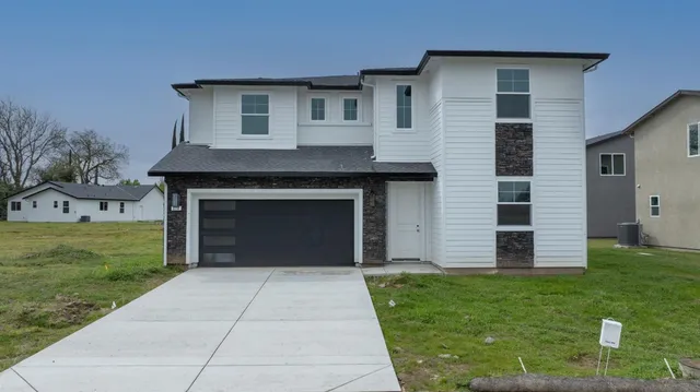 a front view of a house with a yard