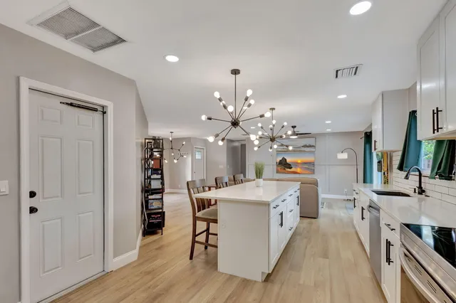 a large kitchen with a table and chairs in it