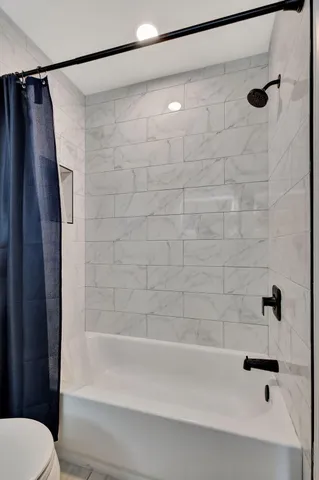 a bathroom with a shower and a toilet