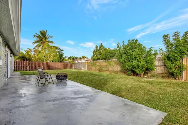 a view of a table and chairs in the garden
