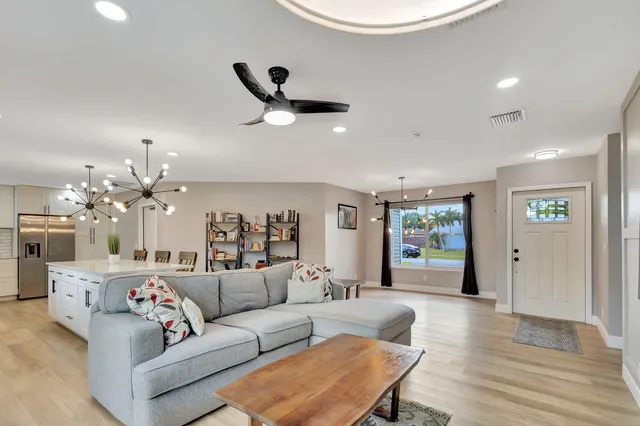 a living room with furniture and a chandelier