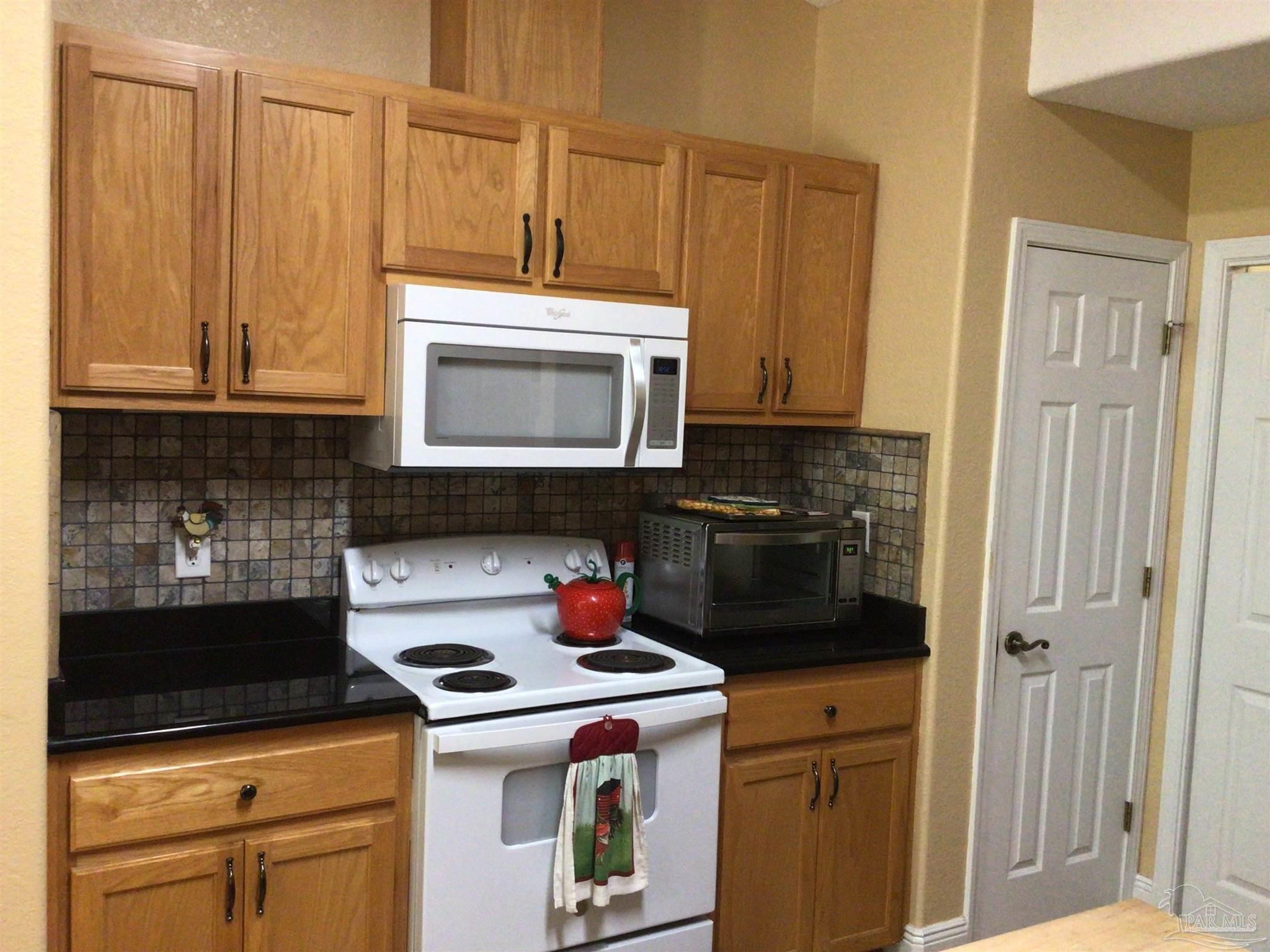 5668 Als Way Milton, FL 32583 - Photo 11 of 48 a kitchen with a stove and a microwave