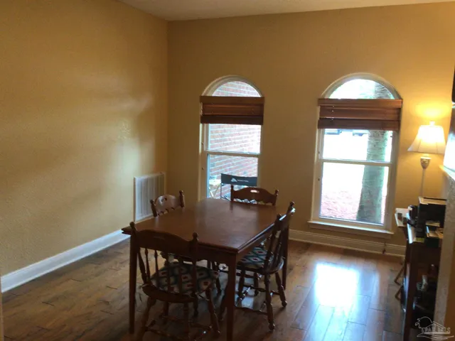 a dining room with furniture and wooden floor