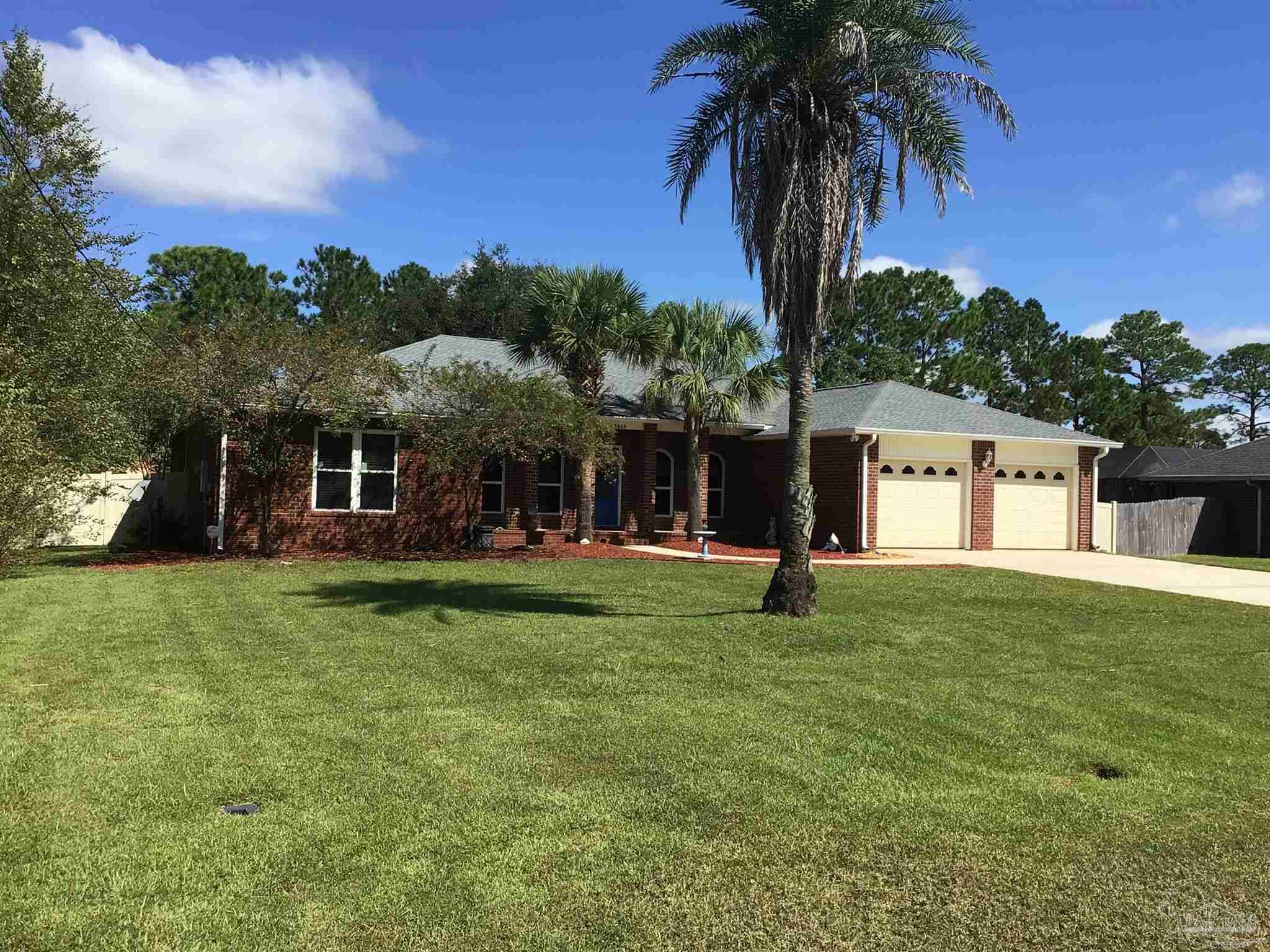 5668 Als Way Milton, FL 32583 - Photo 2 of 48 a front view of a house with garden