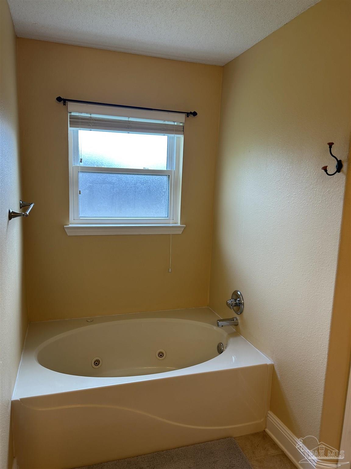 5668 Als Way Milton, FL 32583 - Photo 25 of 48 a bathroom with a bathtub