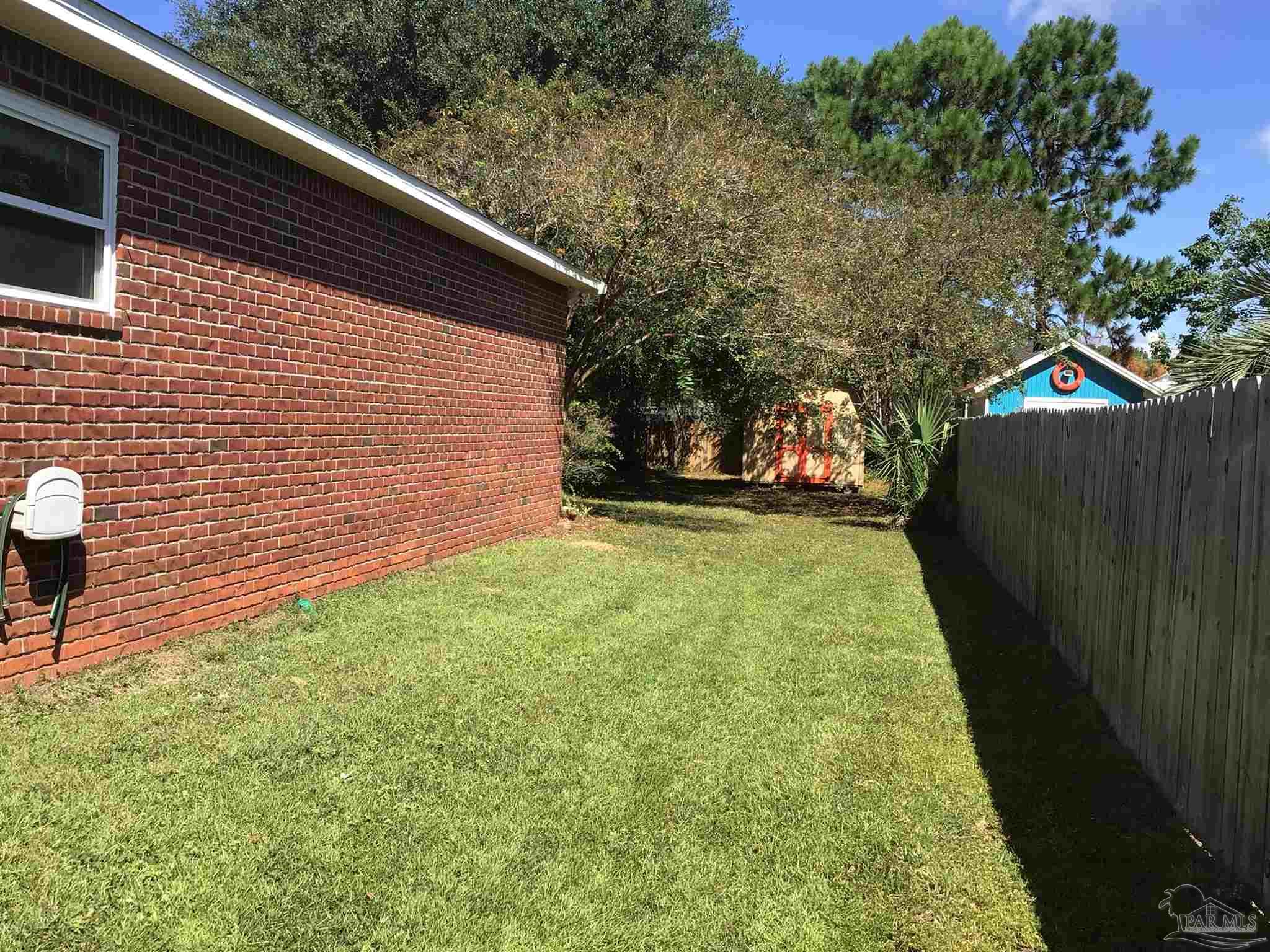 5668 Als Way Milton, FL 32583 - Photo 38 of 48 a backyard of a house with lots of green space