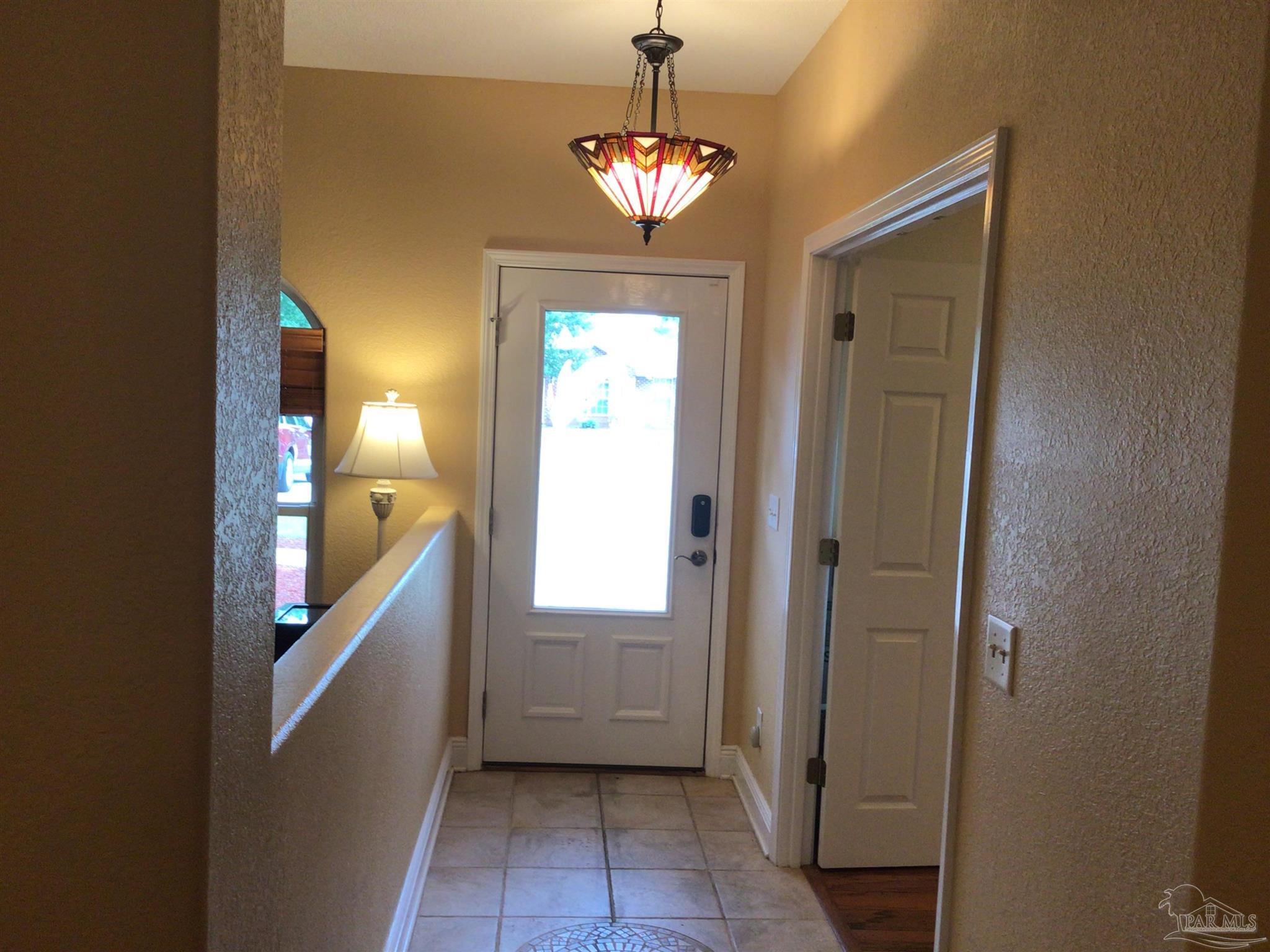 5668 Als Way Milton, FL 32583 - Photo 4 of 48 a view of a hallway with windows and chandelier