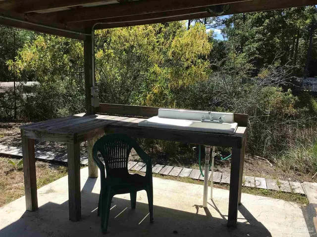 a view of porch with furniture and a yard