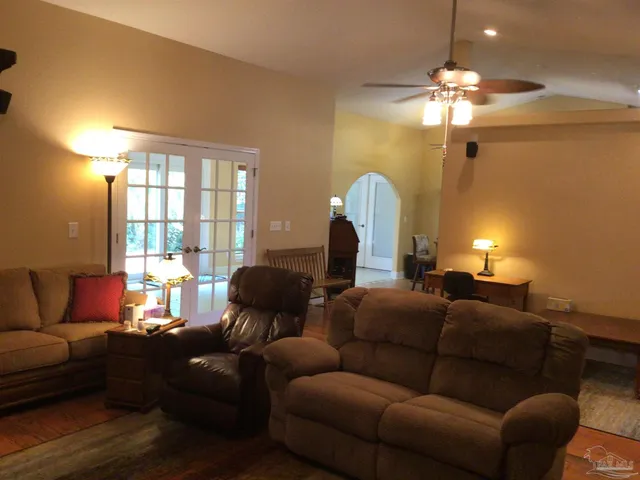 a living room with furniture and a chandelier