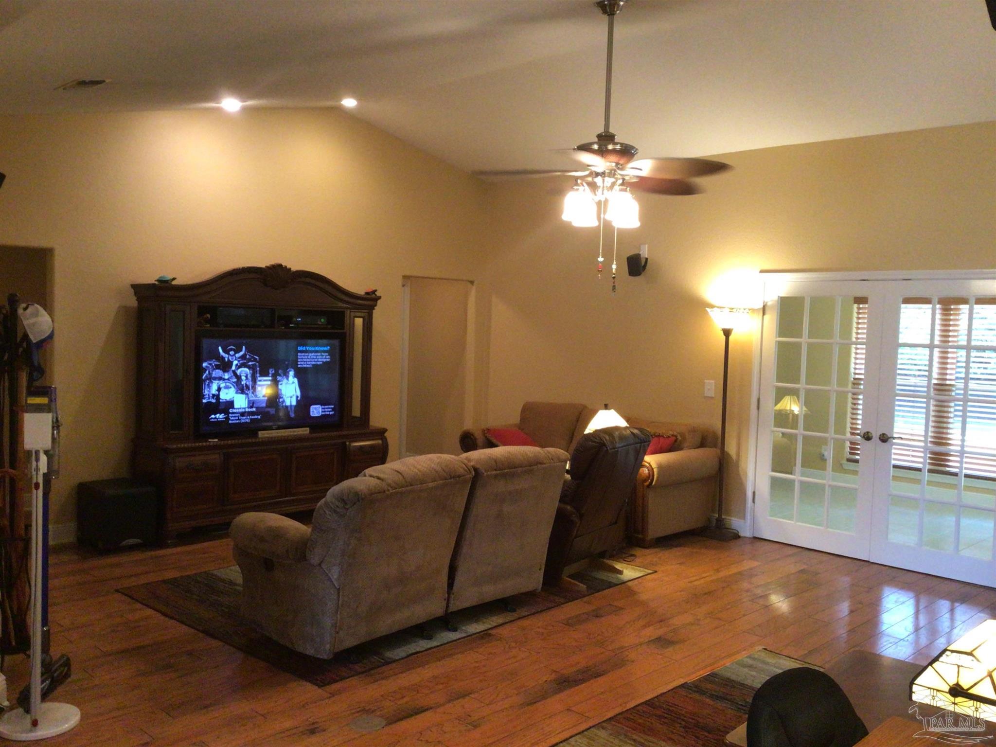 5668 Als Way Milton, FL 32583 - Photo 6 of 48 a living room with furniture a lamp and a fireplace