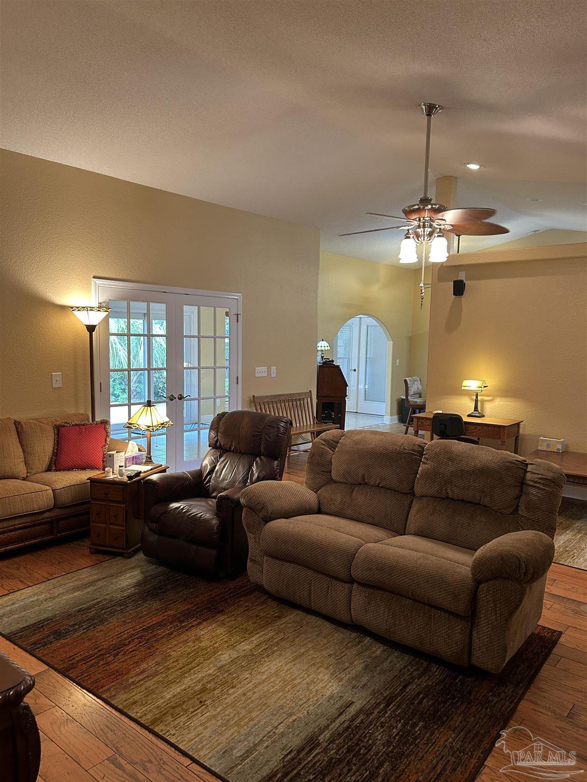 5668 Als Way Milton, FL 32583 - Photo 8 of 48 a living room with furniture and a chandelier