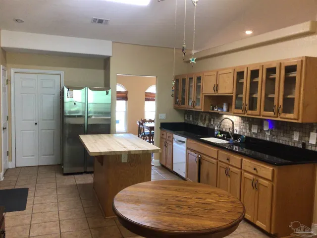 a kitchen with kitchen island a sink stove and cabinets