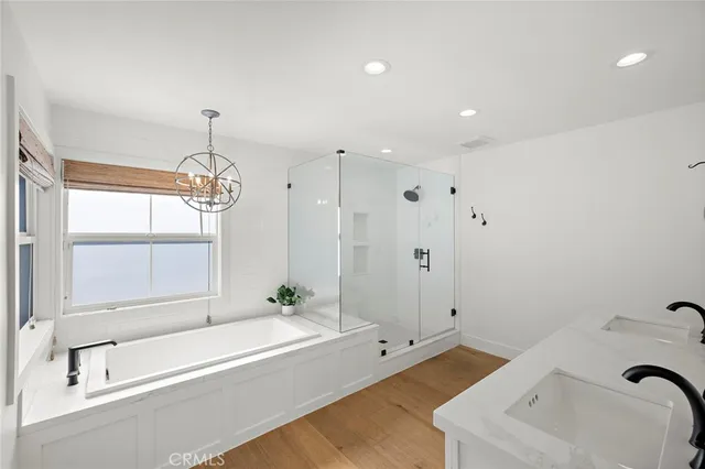 a bathroom with a tub a sink and window