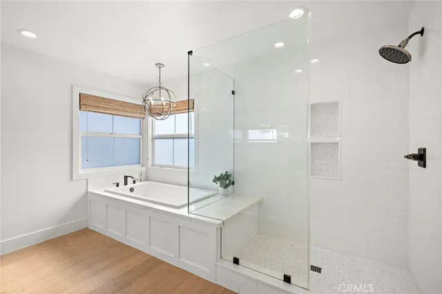 a white bath tub sitting next to a shower