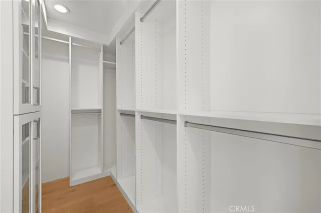 a view of walk in closet with empty racks