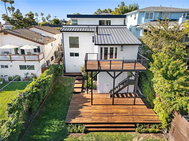 an aerial view of a house with swimming pool and sitting area