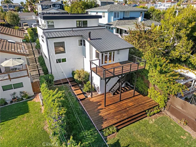 a view of a backyard with couches chair and wooden floor