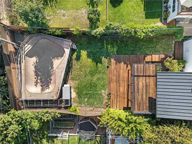 an aerial view of a residential houses with yard