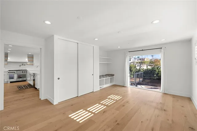 a view of a room with wooden floor and furniture