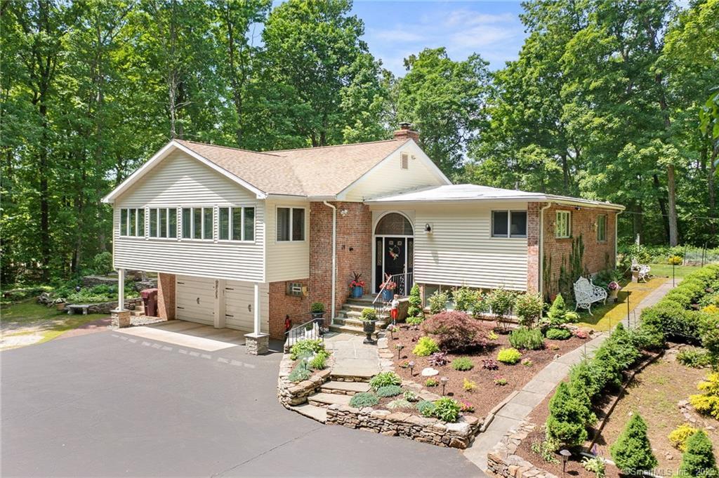 28 White Oak Road Farmington, CT 06032 - Photo 1 of 1 a front view of a house with garden