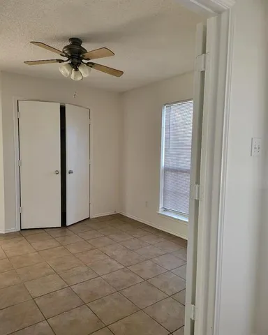 an empty room with a ceiling fan