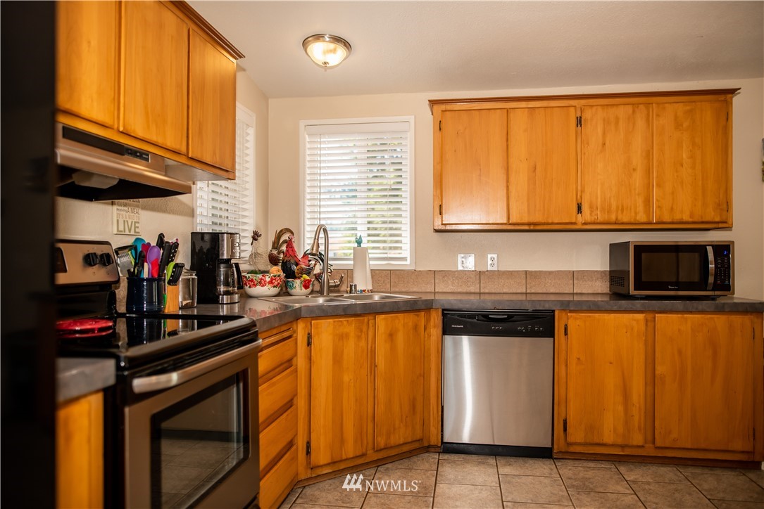 172 Fluckinger Road Toledo, WA 98591 - Photo 15 of 39 a kitchen with stainless steel appliances granite countertop a stove a sink and a microwave