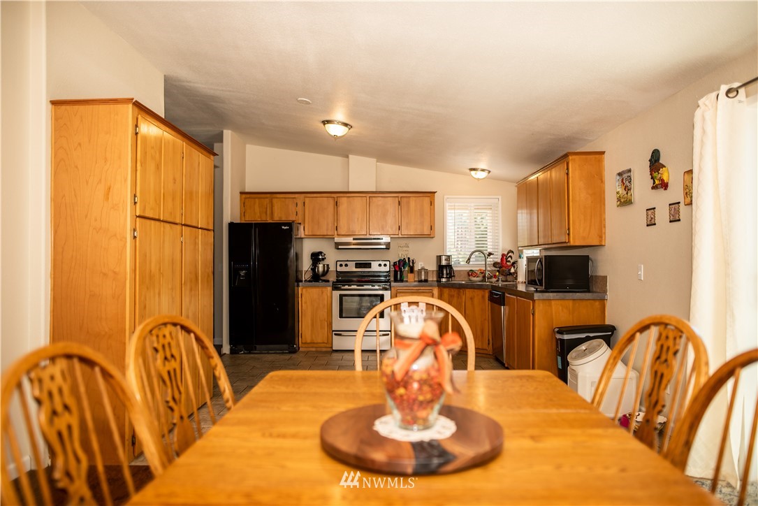 172 Fluckinger Road Toledo, WA 98591 - Photo 18 of 39 a kitchen with stainless steel appliances a dining table and chairs