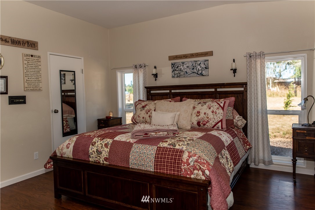 172 Fluckinger Road Toledo, WA 98591 - Photo 19 of 39 a bedroom with a bed and wooden floor
