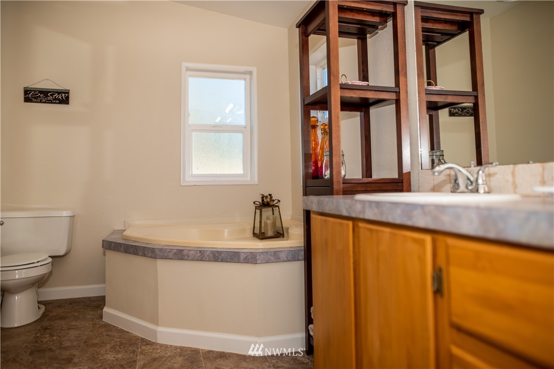 172 Fluckinger Road Toledo, WA 98591 - Photo 20 of 39 a bathroom with a granite countertop sink and a mirror