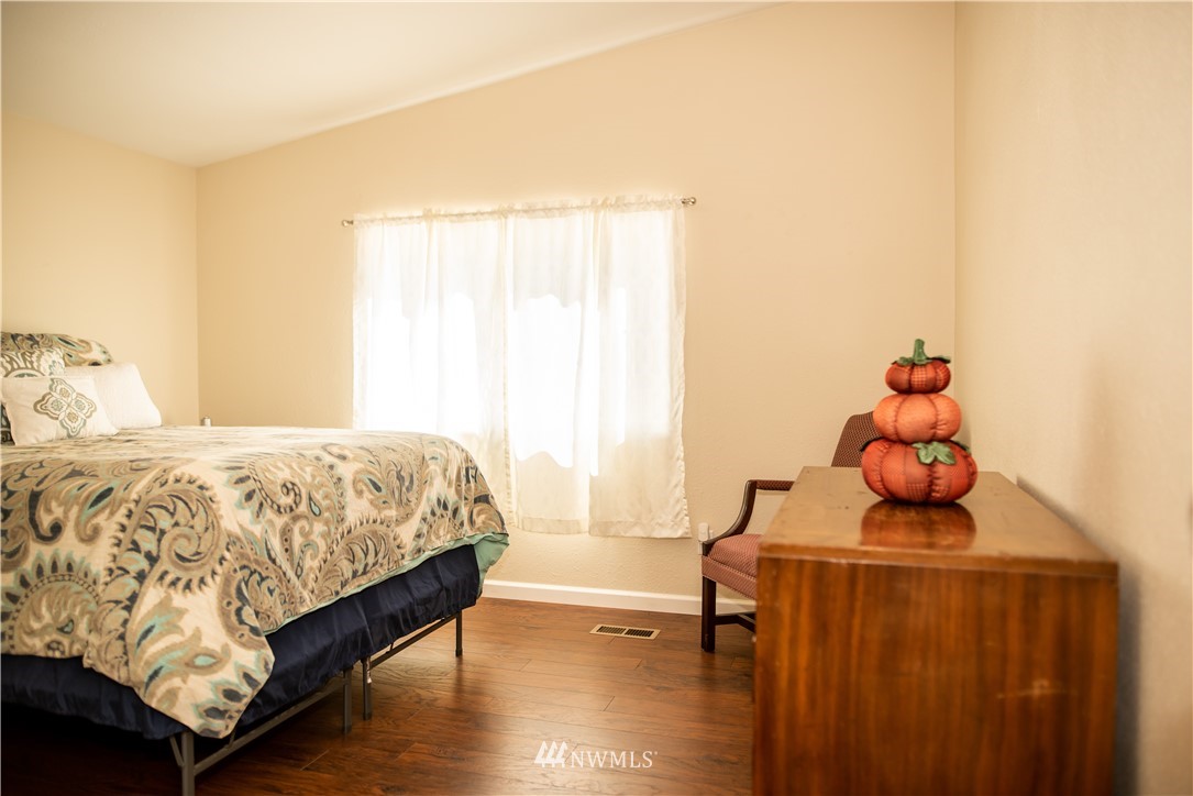 172 Fluckinger Road Toledo, WA 98591 - Photo 21 of 39 a bedroom with a bed and wooden floor