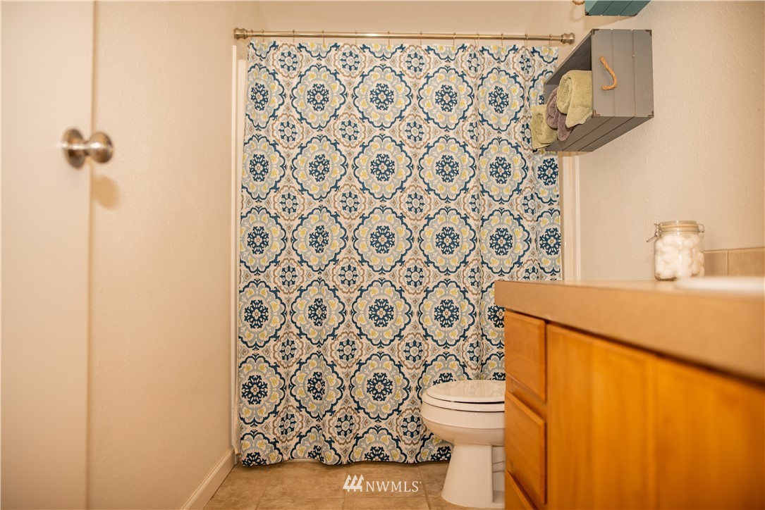 172 Fluckinger Road Toledo, WA 98591 - Photo 23 of 39 a bathroom with a toilet and a shower curtain
