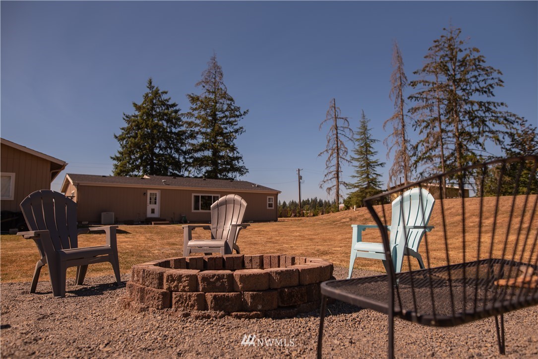 172 Fluckinger Road Toledo, WA 98591 - Photo 32 of 39 a backyard of a house with table and chairs