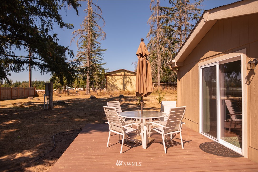 172 Fluckinger Road Toledo, WA 98591 - Photo 6 of 39 a view of a patio with table and chairs with wooden floor and fence