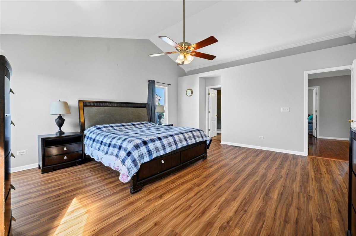322 Zinnia Drive Romeoville, IL 60446 - Photo 15 of 42 a bedroom with a bed and wooden floor