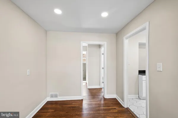 a view of a hallway with wooden floor